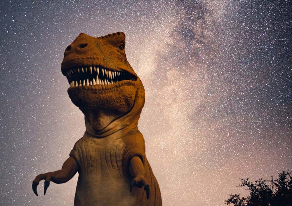 Tyrannosaurus rex walking with starry sky behind