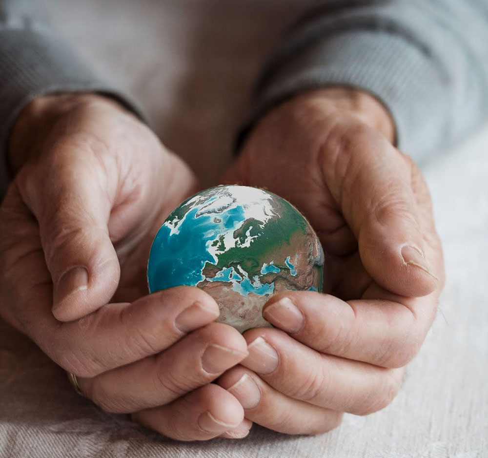 hands holding planet earth in palms